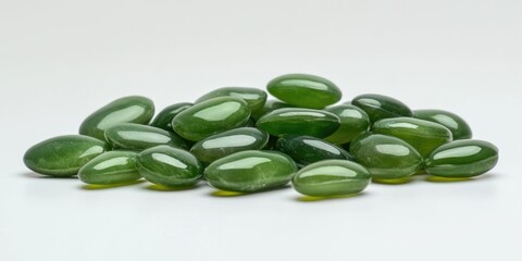 Green glass pebbles on white background