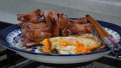 put the fried egg and baked vienna sausage on a plate