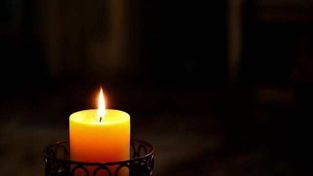 A candle burns in the dark, to light a candle, stutter candle.