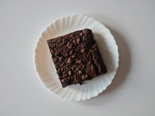 Dark Chocolate Brownie Cake on a White Plate