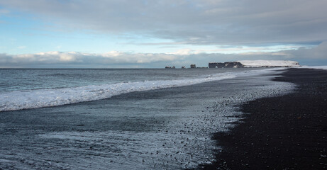 Beautiful Reynisfjara black sand beach located in Vik Iceland. Photo taken on a cloudy winter morning