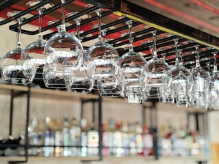 Goreme, Cappadocia, Turkey - December 1, 2024: Rows of wine glasses hanging upside down on metal...