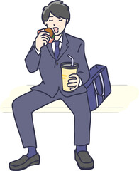 ファーストフードを座って食べる男子学生　全身