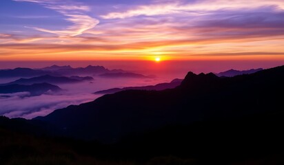 Vibrant sunset paints the sky with purple hues and an orange glow, silhouetting mountains in a panoramic, ethereal landscape. A breathtaking twilight scene of nature's serene beauty.