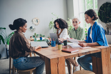 Portrait of team ambitious business women laptop documents desk modern interior office indoors