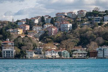 Beautiful view of the Bosphorus shore on a sunny day, full of residential houses, Istanbul, Turkey.