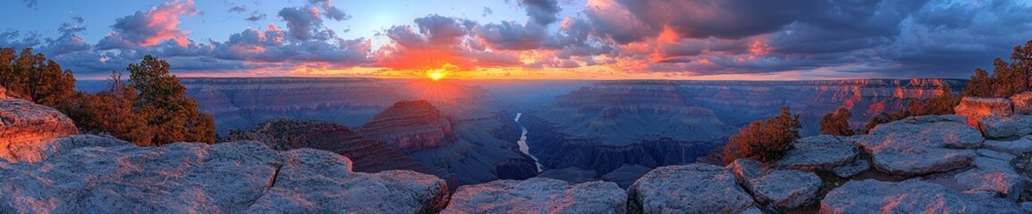Fototapeta premium The Grand Canyon offers a breathtaking panorama with red earth dominating the valley and a dramatic red sky on the horizon