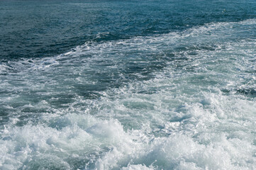 A trail of bubbling, foaming seawater from a ferry, Bosphorus, Turkey. Ocean weaves.