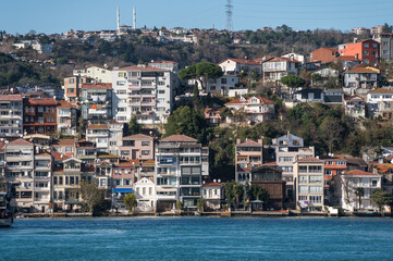 Beautiful view of the Bosphorus shore on a sunny day, full of residential houses, Istanbul, Turkey.
