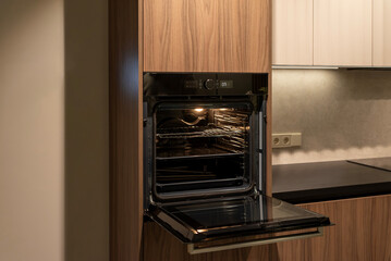 Modern built-in oven with open door, ready for cooking