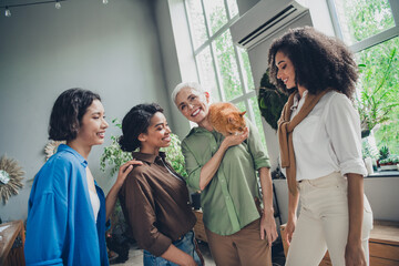 Obraz premium Photo of successful corporate women good mood play orange cat modern interior office business center indoors