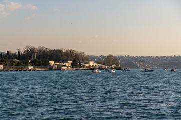Beautiful sunset view of the Bosphorus coast, seagulls and boats Istanbul, Turkey.