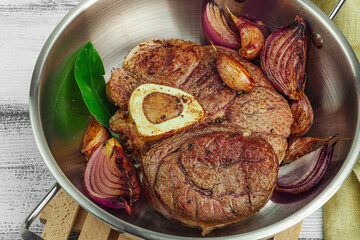 Ossobuco beef meat with spices and fresh herbs. Veal shank steak, traditional Italian ingredient