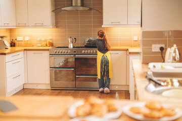 Young child bakes cookies in a modern kitchen during the afternoon