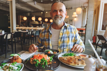 Enjoying  delicious meal in modern restaurant on sunny afternoon