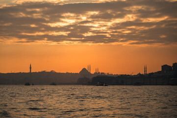 Fototapeta premium Beautiful view of the Bosphorus and the mosque in the background at sunset. View of Fatih district