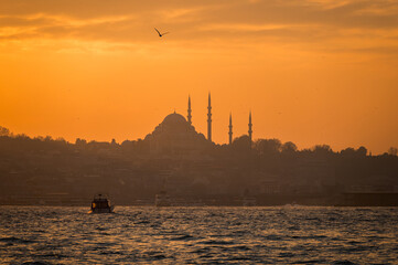 Beautiful view of the Bosphorus and the mosque in the background at sunset. View of Fatih district