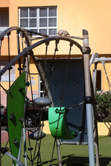 Two pigeons sitting on a climbing frame on children's  playground
