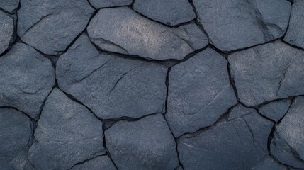 Fototapeta premium Close-up of volcanic basalt with natural pores and dark matte tones, evoking a raw and edgy wallpaper texture