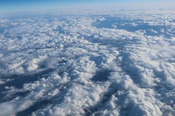   White cumulus fluffy clouds wallpaper taken from the plane in a blue sky good weather day