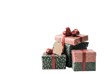 A festive pile of gift boxes decorated with holiday-themed wrapping paper and bows, with a small tag attached to one of the presents.