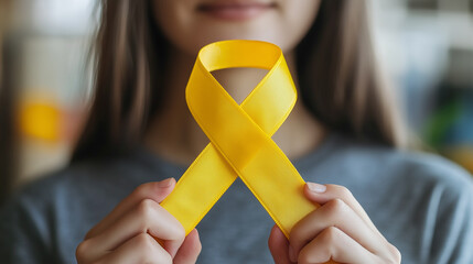 Yellow suicide prevention awareness ribbon isolated on white background