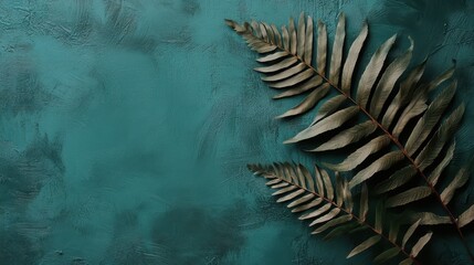 Green fern leaves on teal background, flat lay, copy space