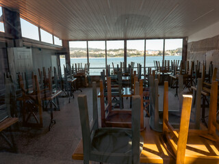 Closed Waterfront Restaurant Interior with Stacked Chairs