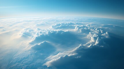Fototapeta premium Aerial view of fluffy clouds illuminated by sunlight in a serene blue sky.