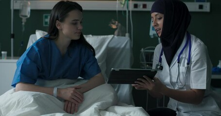 Arab doctor shows good test results to a patient.