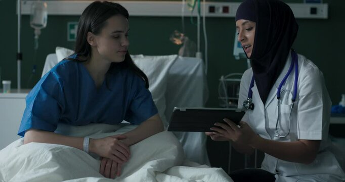 Arab doctor shows good test results to a patient.