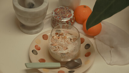 Overnight oat with nuts and raisins served on a table in a cozy springtime breakfast setup showing a relaxing and healthy morning routine