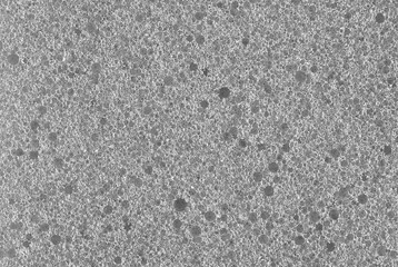 gray background, photo shows texture of gray foam sponge close-up
