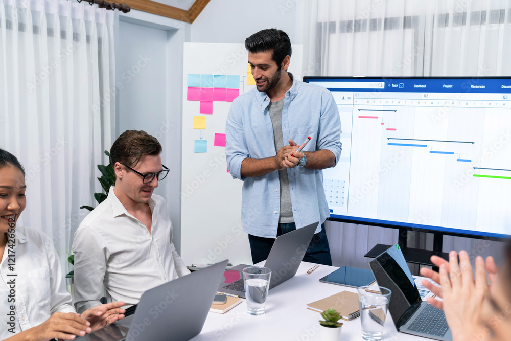 Leinwandbilder Project manager communicate and collaborate with team using project management software display on monitor, tracking progress of project task and making schedule plan at meeting table. Prudent