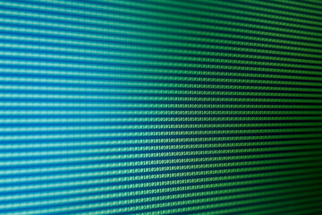 Close-up of a digital display featuring binary code in blue and green tones, representing technology and data. Ideal for tech-related projects.