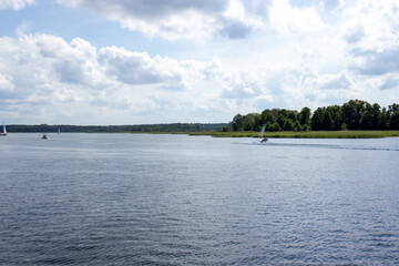 Serene landscape featuring a tranquil river, lush greenery, and a picturesque sky. Ideal for nature, travel, and outdoor themes.