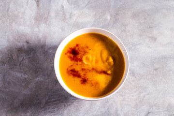 Pumpkin soup flat lay. Cream soup with paprika and chili pepper. Vegetable soup for vegan. Healthy eating. Concept of resaturant cafe healthy eating