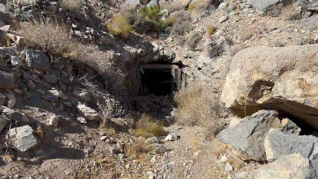Weathered and mysterious, an abandoned historic mine entrance near Beatty, Nevada, stands as a silent testament to the region's rich mining heritage, inviting exploration of the American West's gold r