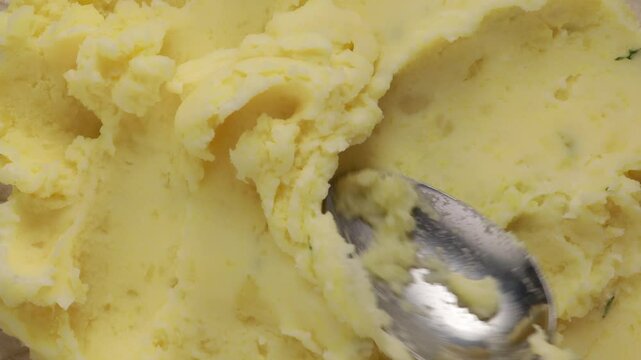 top view of texture mashed potatoes with butter and green