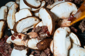 stir-frying the seasoned beef and shiitake mushroom