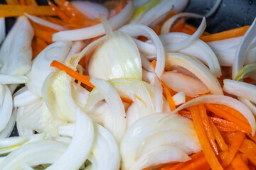stir-frying the slices of carrot and onion