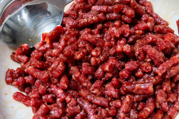 seasoning the beef with soy sauce, cooking oil and sesame sauce