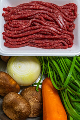 uncooked beef and fresh vegetables