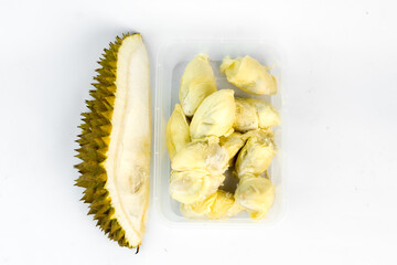 Pieces of fresh durian fruit are neatly arranged within a transparent plastic container. The golden-yellow durian pulp contrasts against the white background