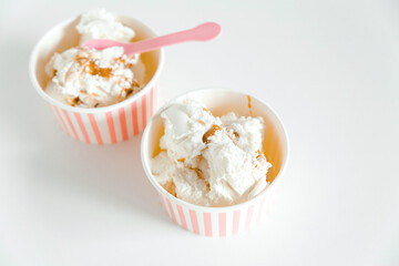 Ice cream boxes and cute pink spoons. White background