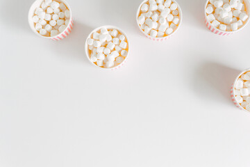 Minimalist white background with marshmallow boxes. Mockup for design, template with copy space. Stylish sweet background.