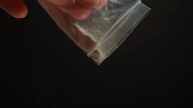 Person planning to get high with illegal dangerous street opioid Fentanyl drugs, white powder crystalline. Widespread misuse of prescription drugs. Illegal drug markets and Over prescription addiction