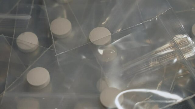 Seized by police, Oxy, Meth, Fentanyl or synthetic opioid drugs. Powder drugs pressed in pills shape and packaged in to small plastic bags for transportation and sale in clubs, party and streets.