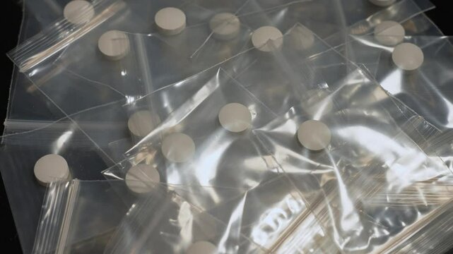 Seized by police, Oxy, Meth, Fentanyl or synthetic opioid drugs. Powder drugs pressed in pills shape and packaged in to small plastic bags for transportation and sale in clubs, party and streets.