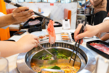 Shabu Shabu, a popular dish of pork, beef, squid, seafood and fresh vegetables. Placed on a table with a boiling pot boiling.
